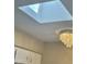 The home offers a skylight, and a chandelier can be seen in the background at 9021 W Elm St # 7, Phoenix, AZ 85037
