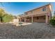 Backyard featuring a covered patio, pool, gravel and privacy wall at 9234 W Hedge Hog Pl, Peoria, AZ 85383
