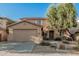 Charming two-story home featuring a neutral color palette, two-car garage, and desert landscaping at 9234 W Hedge Hog Pl, Peoria, AZ 85383