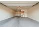 Spacious two car garage featuring overhead lighting and concrete floors at 9234 W Hedge Hog Pl, Peoria, AZ 85383