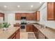 Kitchen features stainless steel appliances, granite counters, and wood cabinets at 9234 W Hedge Hog Pl, Peoria, AZ 85383