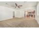 Open-concept living room with carpet flooring, and archways to other rooms at 9234 W Hedge Hog Pl, Peoria, AZ 85383