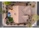 An aerial view shows the property's well-maintained tile roof, backyard pool and lush landscaping at 14424 N 64Th Pl, Scottsdale, AZ 85254