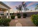 Tranquil backyard with a covered patio, rock landscaping, and desert plants at 14424 N 64Th Pl, Scottsdale, AZ 85254