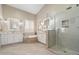 Well-lit bathroom with a soaking tub, walk-in shower, and double vanities with ample counter space at 14424 N 64Th Pl, Scottsdale, AZ 85254