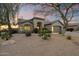 Charming single-story home with a desert-landscaped yard, inviting entrance, and attached two-car garage at 14424 N 64Th Pl, Scottsdale, AZ 85254