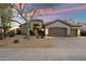 Charming single-story home with desert landscaping, two-car garage, and an inviting front entryway at 14424 N 64Th Pl, Scottsdale, AZ 85254