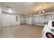Spacious three-car garage with ample storage cabinets and organized shelving at 14424 N 64Th Pl, Scottsdale, AZ 85254