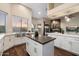 Beautiful kitchen with a large island, a stainless steel sink, modern appliances, and custom cabinetry at 14424 N 64Th Pl, Scottsdale, AZ 85254