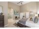Bright main bedroom with king bed, ceiling fan, and en-suite bathroom with a walk-in shower at 14424 N 64Th Pl, Scottsdale, AZ 85254