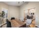Spacious office space with wood desk, shutters, and view into the dining area at 14424 N 64Th Pl, Scottsdale, AZ 85254