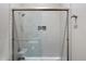 Modern shower with white subway tile and glass doors at 14424 N 64Th Pl, Scottsdale, AZ 85254