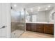 Modern bathroom featuring a glass shower, dual sinks and contemporary cabinets at 21278 N 272Nd Ave, Buckeye, AZ 85396