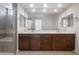 Bathroom featuring double vanity with undermount sinks and a glass shower with bench at 21278 N 272Nd Ave, Buckeye, AZ 85396