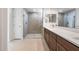 Bathroom boasting double sink vanity with shaker cabinets and large glass shower at 21278 N 272Nd Ave, Buckeye, AZ 85396