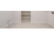Spacious laundry room with tiled floor, ample shelving, and hookups for a washer and dryer at 21278 N 272Nd Ave, Buckeye, AZ 85396