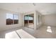 Bright, sunlit living room with tiled floors, large windows, and neutral walls at 21278 N 272Nd Ave, Buckeye, AZ 85396