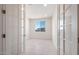 Office space featuring neutral tile, white trim, and glass French doors, with a window providing a view of the neighborhood at 21278 N 272Nd Ave, Buckeye, AZ 85396