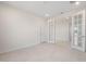 Office space featuring neutral tile, white trim, and glass French doors, with a window providing a view of the neighborhood at 21278 N 272Nd Ave, Buckeye, AZ 85396