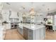 Elegant kitchen featuring a large island, stainless steel appliances, and stylish pendant lighting at 2625 N 24Th St # 13, Mesa, AZ 85213