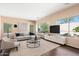 Bright living room with hardwood floors, large windows, and stylish modern furnishings at 3002 W Donatello Dr, Phoenix, AZ 85086