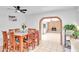 Dining room with a decorative ceiling fan, a view to another room through a brick archway at 625 S Daley --, Mesa, AZ 85204