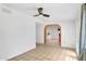 Open dining space featuring white walls, tile floors, and arched doorway to the kitchen at 625 S Daley --, Mesa, AZ 85204