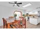 Open concept kitchen and dining room features stainless steel appliances, island, and a ceiling fan at 625 S Daley --, Mesa, AZ 85204