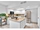 Spacious kitchen featuring a large island, stainless steel refrigerator, microwave, and white cabinetry at 625 S Daley --, Mesa, AZ 85204