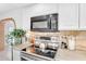 Close up of stainless steel stove, microwave, and granite countertops in bright updated kitchen at 625 S Daley --, Mesa, AZ 85204