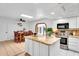 Bright kitchen features a center island with granite countertops, stainless steel appliances, and white cabinets at 625 S Daley --, Mesa, AZ 85204