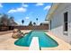 Backyard pool with diving board is surrounded by rocks and walls at 625 S Daley --, Mesa, AZ 85204