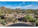 An aerial view showcasing an upscale community and custom homes with mountain views on a sunny day at 10057 E Blue Sky Dr, Scottsdale, AZ 85262