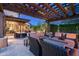 Covered outdoor living space features comfortable seating, a fireplace, and desert views for relaxing and entertaining at 10057 E Blue Sky Dr, Scottsdale, AZ 85262