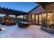 Charming backyard boasts covered patio with fireplace, outdoor dining area, and stone facade home exterior at 10057 E Blue Sky Dr, Scottsdale, AZ 85262