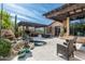 Outdoor patio features a pool, dining, fireplace and lounge areas surrounded by desert landscaping and blue skies at 10057 E Blue Sky Dr, Scottsdale, AZ 85262