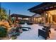 Beautiful backyard with a pool, spa, fireplace, built-in grill and outdoor seating under a pergola at 10057 E Blue Sky Dr, Scottsdale, AZ 85262