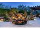 Picturesque backyard featuring a rock waterfall, lush desert foliage, and tranquil pool area at 10057 E Blue Sky Dr, Scottsdale, AZ 85262