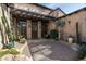 Inviting courtyard with desert landscaping, stone accents, and wooden pergola at 10057 E Blue Sky Dr, Scottsdale, AZ 85262