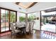 Bright dining room with wood floors, beamed ceilings and access to outdoor dining area at 10057 E Blue Sky Dr, Scottsdale, AZ 85262