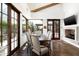 Bright dining room with wood floors, beamed ceilings, fireplace and scenic desert views at 10057 E Blue Sky Dr, Scottsdale, AZ 85262
