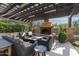 Covered patio showcasing an outdoor fireplace and comfortable seating with a fire pit for entertaining at 10057 E Blue Sky Dr, Scottsdale, AZ 85262