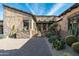 Stunning front yard with desert landscaping, brick pathway, and stucco exterior at 10057 E Blue Sky Dr, Scottsdale, AZ 85262