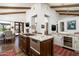 Open kitchen with a granite island, custom cabinets, and stainless steel appliances at 10057 E Blue Sky Dr, Scottsdale, AZ 85262