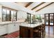 Bright kitchen featuring granite countertops, custom cabinetry and an island with seating at 10057 E Blue Sky Dr, Scottsdale, AZ 85262