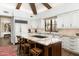 Gourmet kitchen with stone countertops, stainless steel appliances and center island seating at 10057 E Blue Sky Dr, Scottsdale, AZ 85262