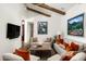 Comfortable living room featuring high ceilings, exposed beams, and open access to other rooms at 10057 E Blue Sky Dr, Scottsdale, AZ 85262