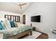 Spacious main bedroom showcases hardwood floors, vaulted ceiling, large windows, and a mounted television at 10057 E Blue Sky Dr, Scottsdale, AZ 85262