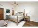Bright main bedroom boasts vaulted ceiling, hardwood floors, and a decorative four-poster bed at 10057 E Blue Sky Dr, Scottsdale, AZ 85262