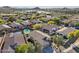 Scenic aerial view of the neighborhood highlighting the lake, lush landscaping, and well-maintained homes at 10224 S 175Th Ave, Goodyear, AZ 85338